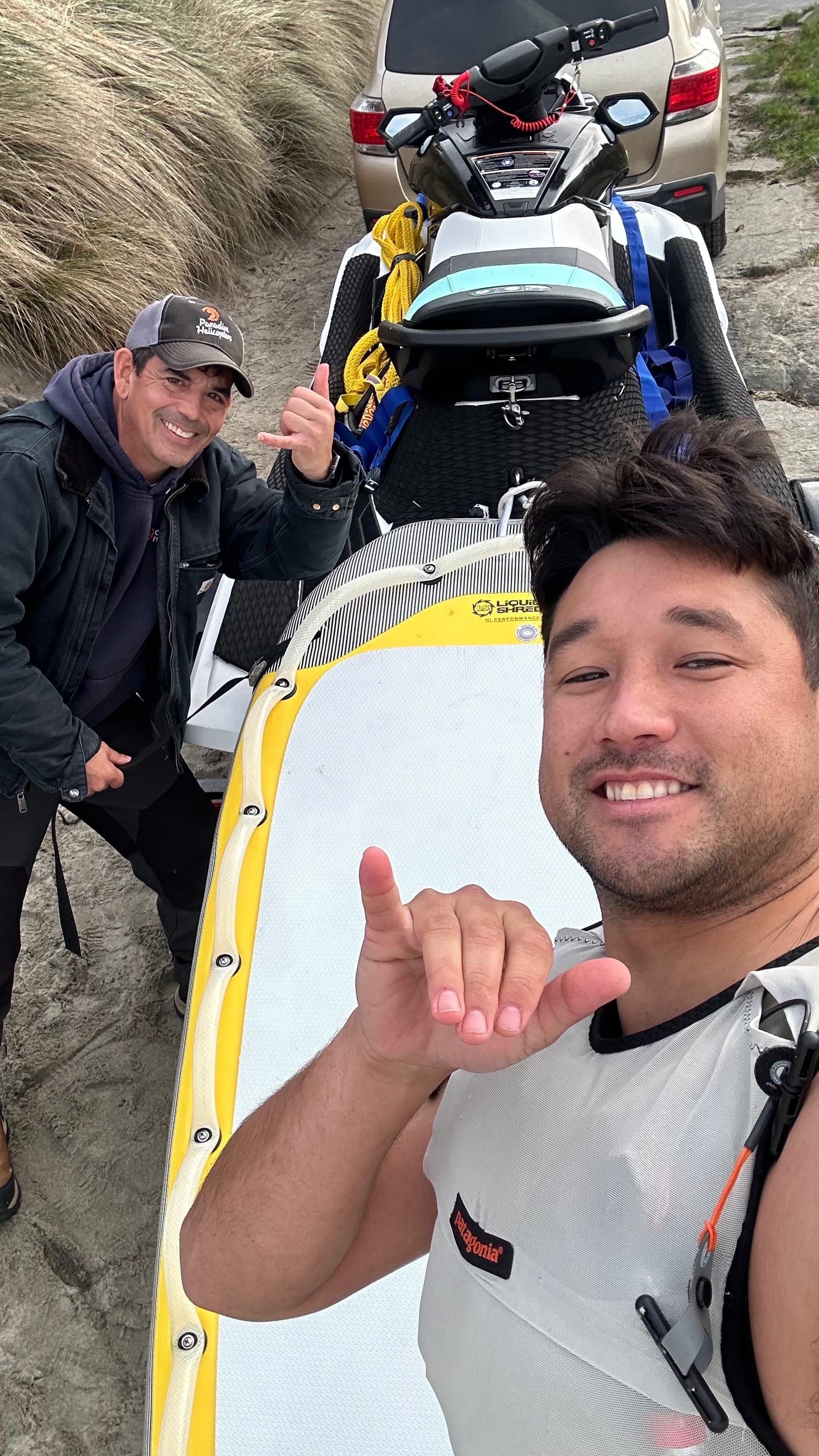 Men posing with a jet ski