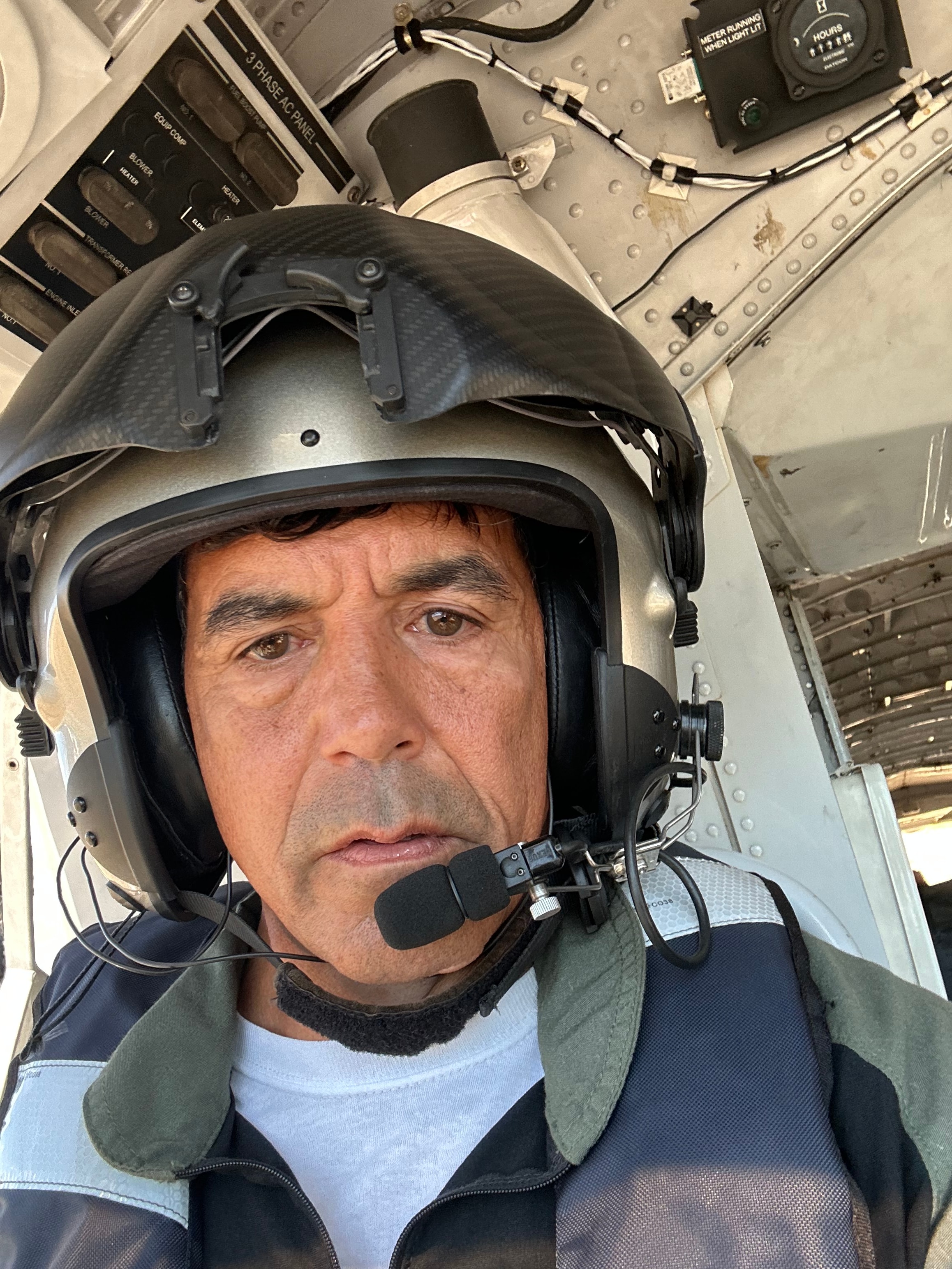 Pilot wearing helmet inside aircraft cockpit