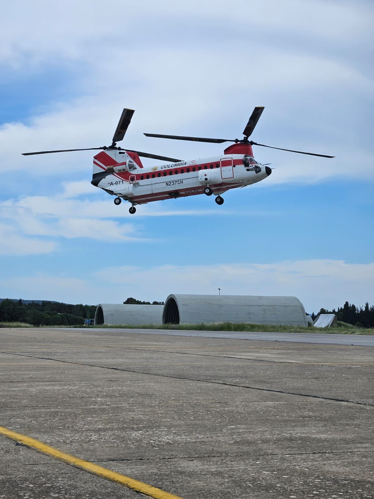 Red and white helicopter on a runway
