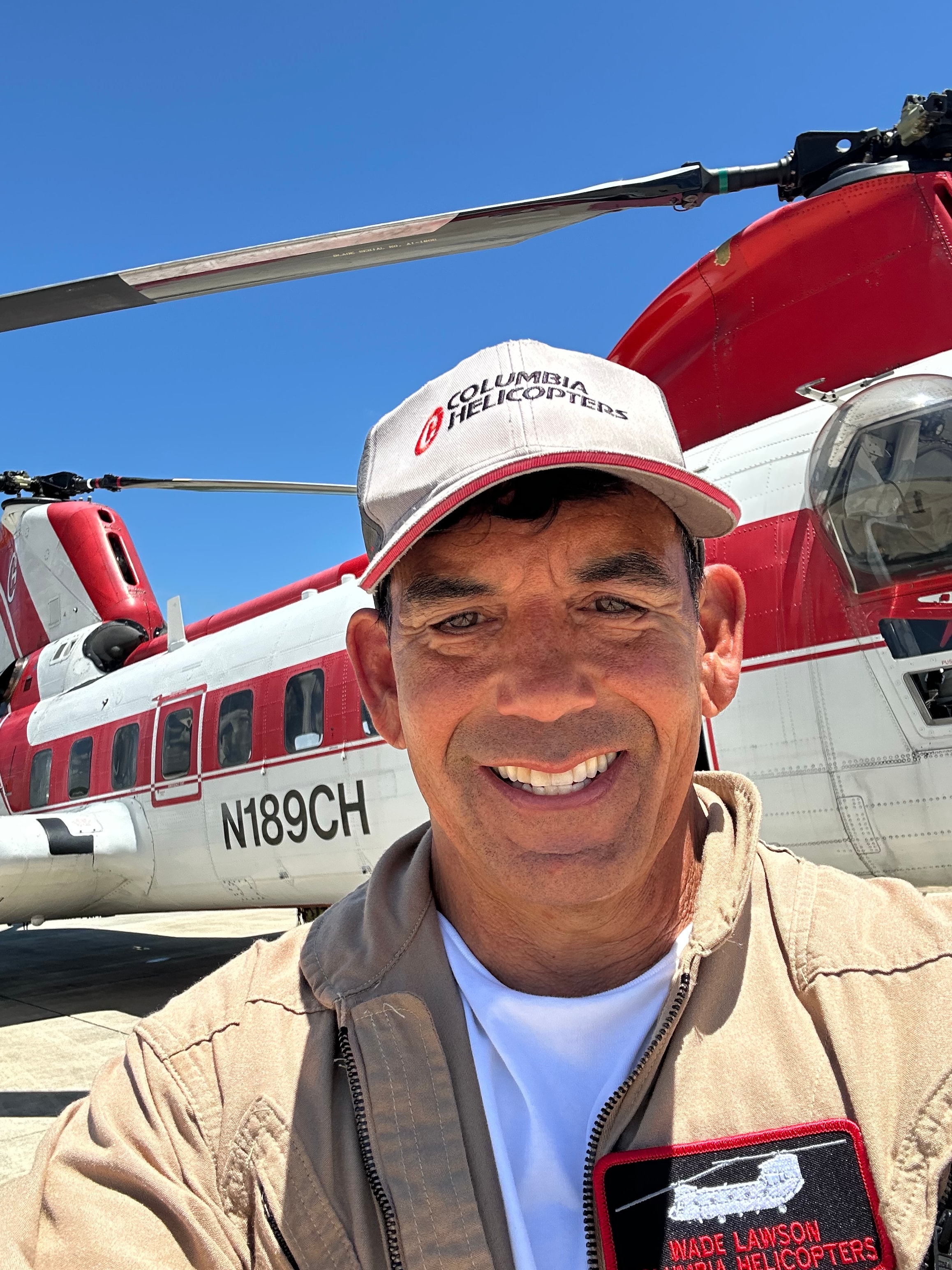 Man posing with red helicopter